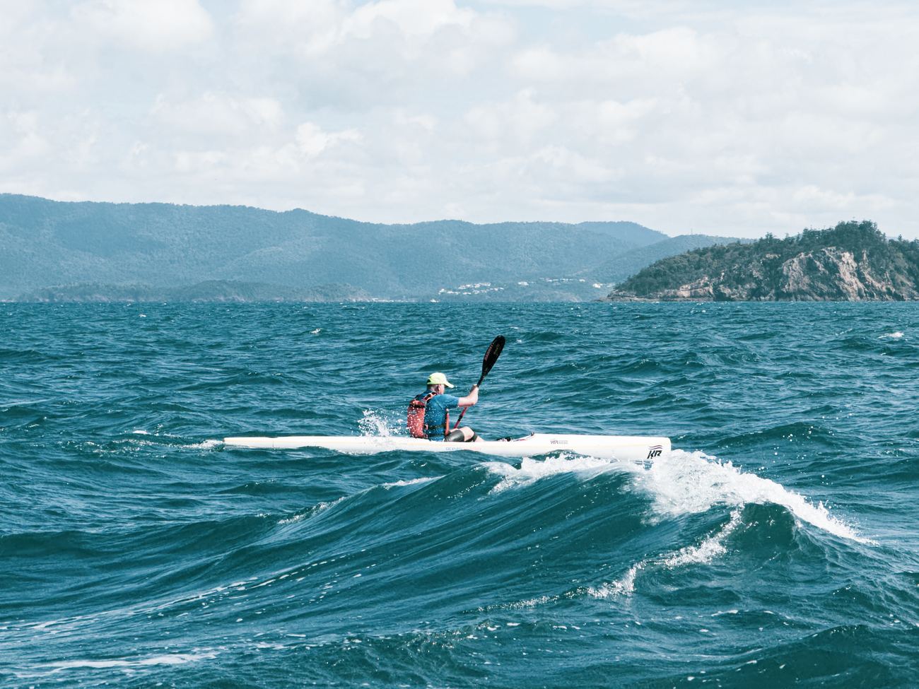 Solo paddler catching a breaking runner