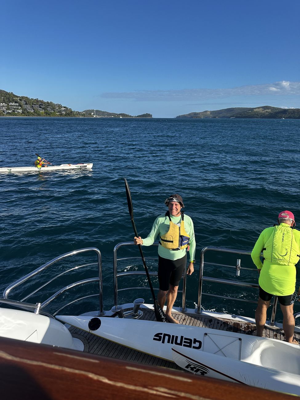 A paddler taking the first strokes away from the yacht