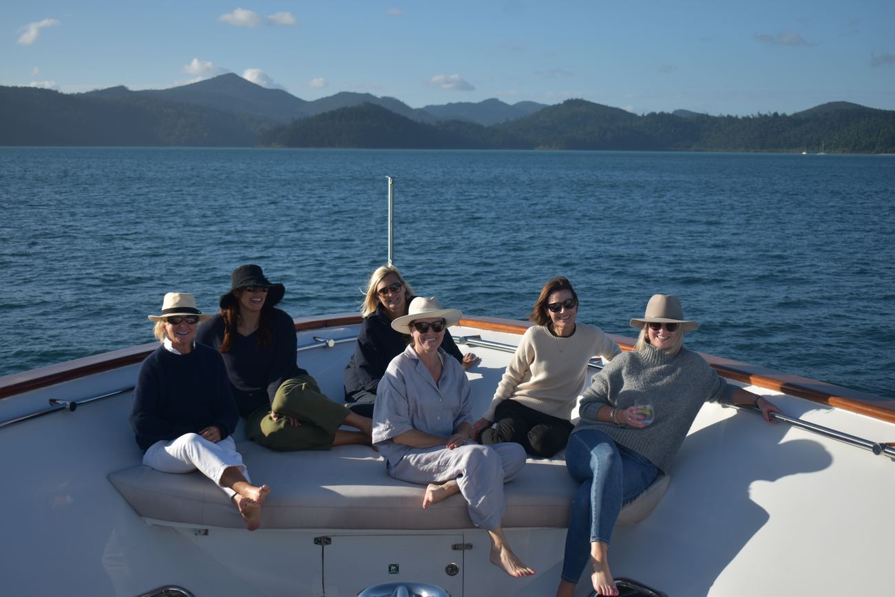 The non-paddlers gathered on the bow cushions watching the fleet