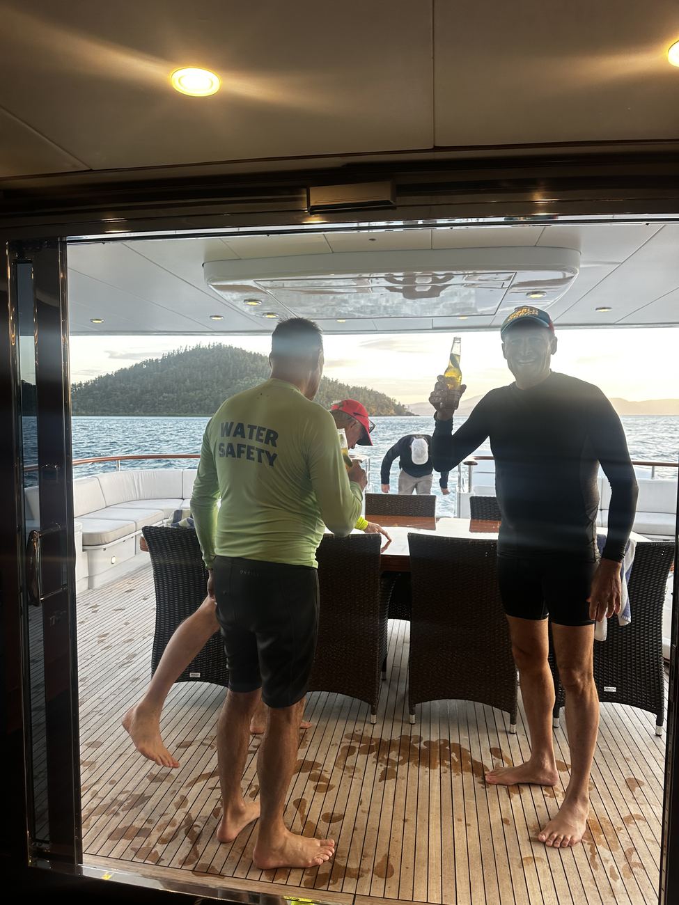 Paddlers with beers on the aft deck after the crossing