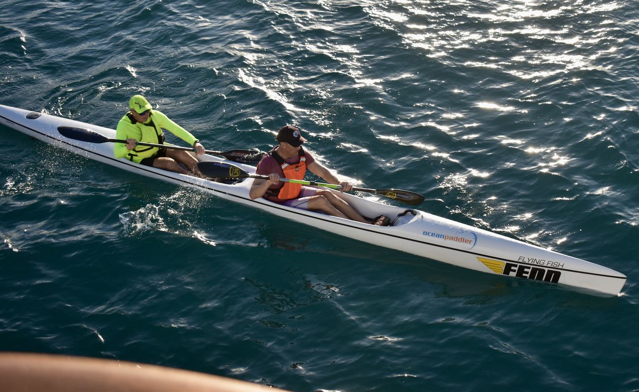 Close shot of a double surf ski, two paddlers mid-stroke