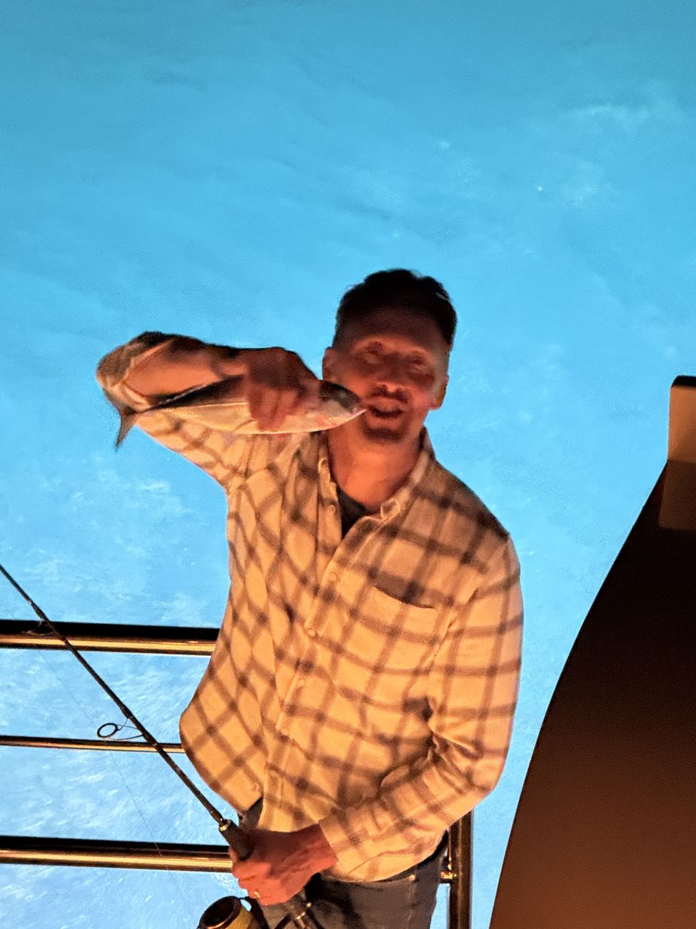 Sean holding up his catch, grinning