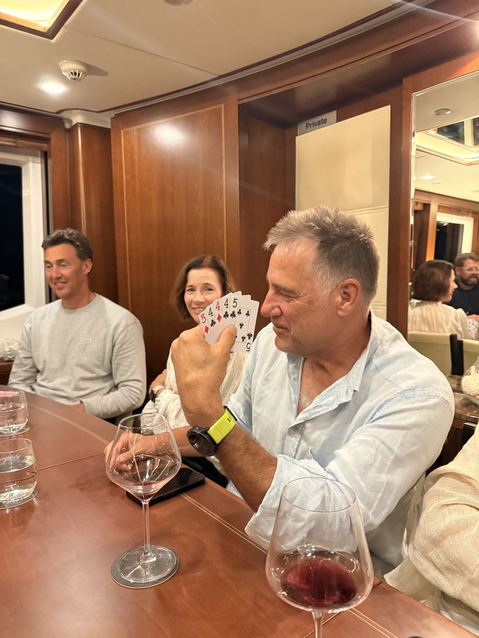 A winning hand of cards held up at the table
