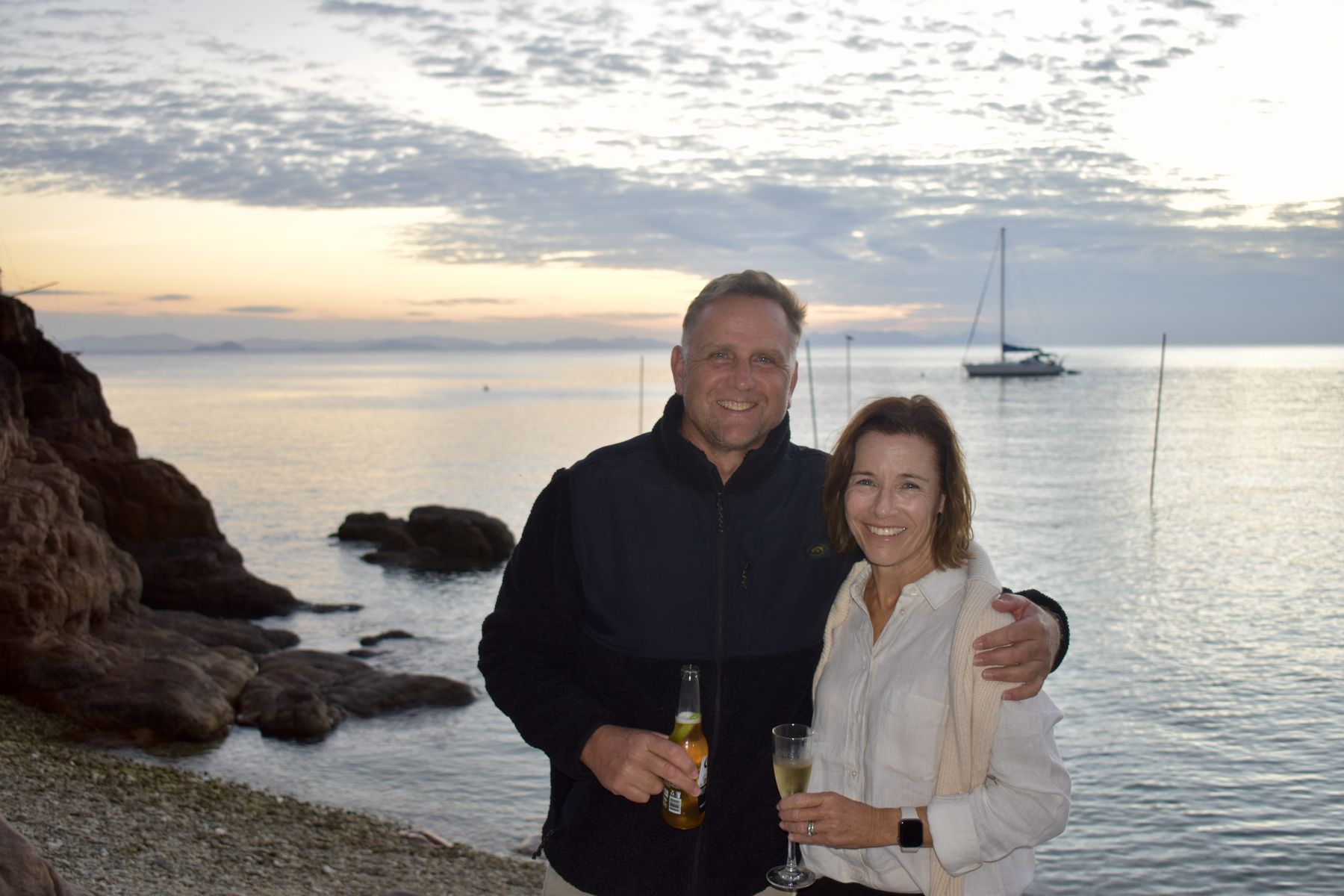 Couple portrait on the coral beach at golden hour