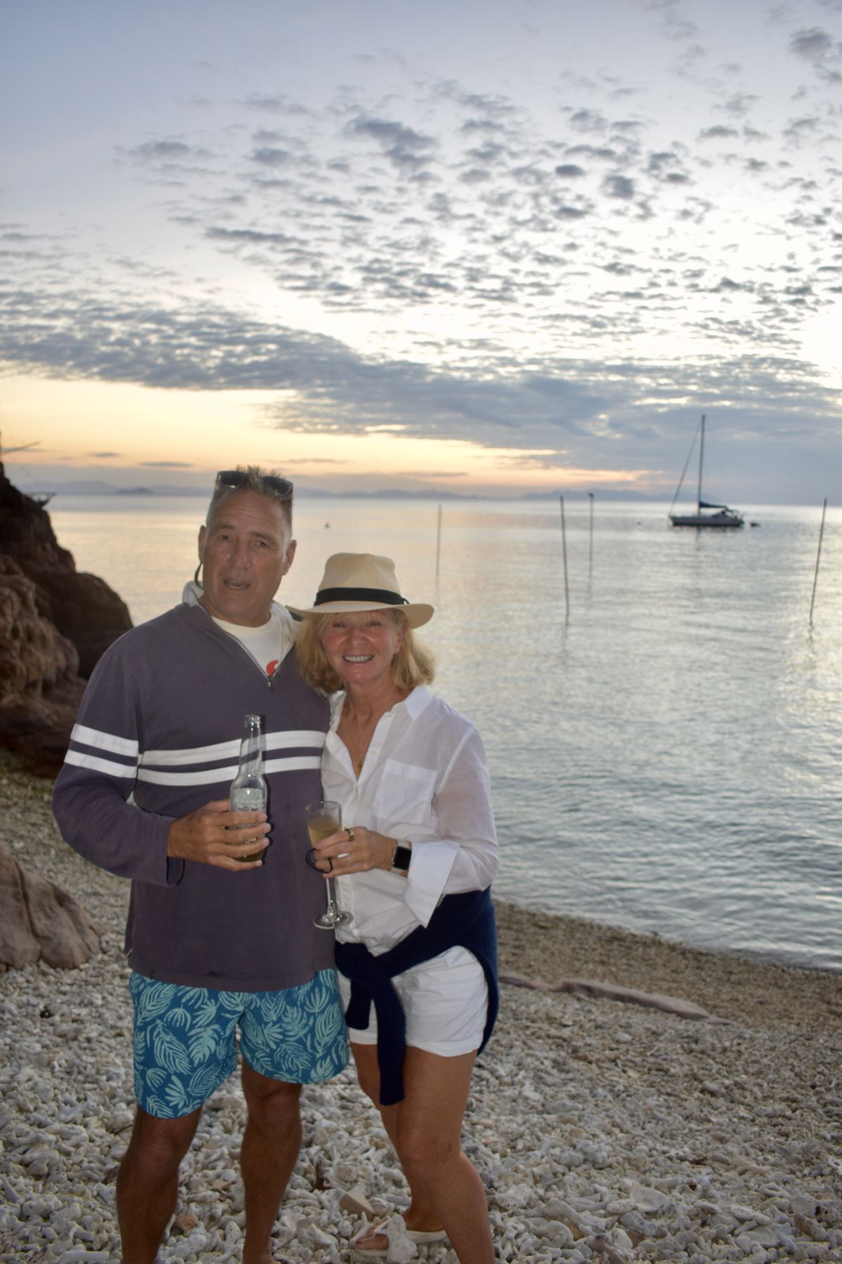 Couple portrait on the coral beach at golden hour