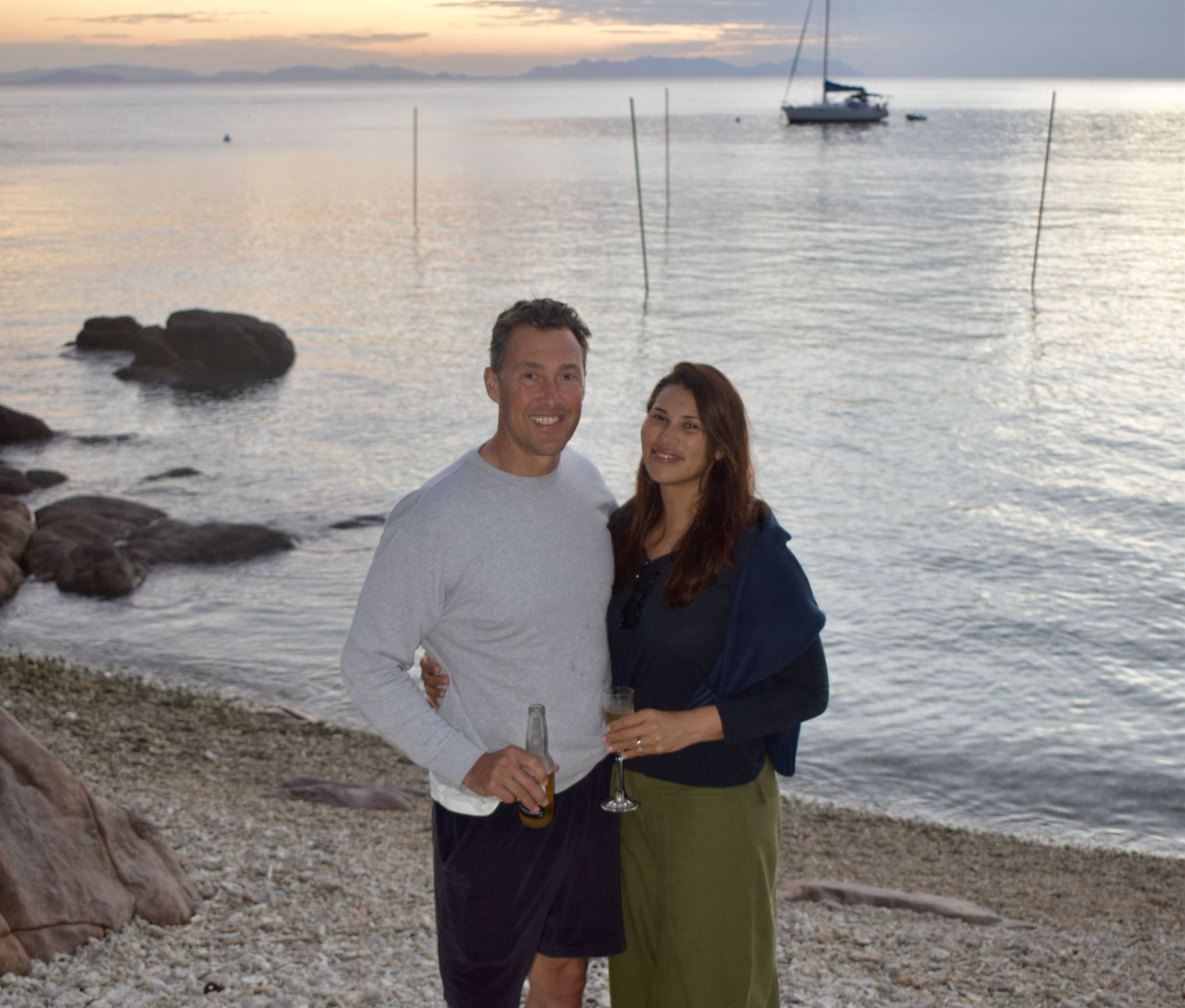 Couple portrait on the coral beach at golden hour