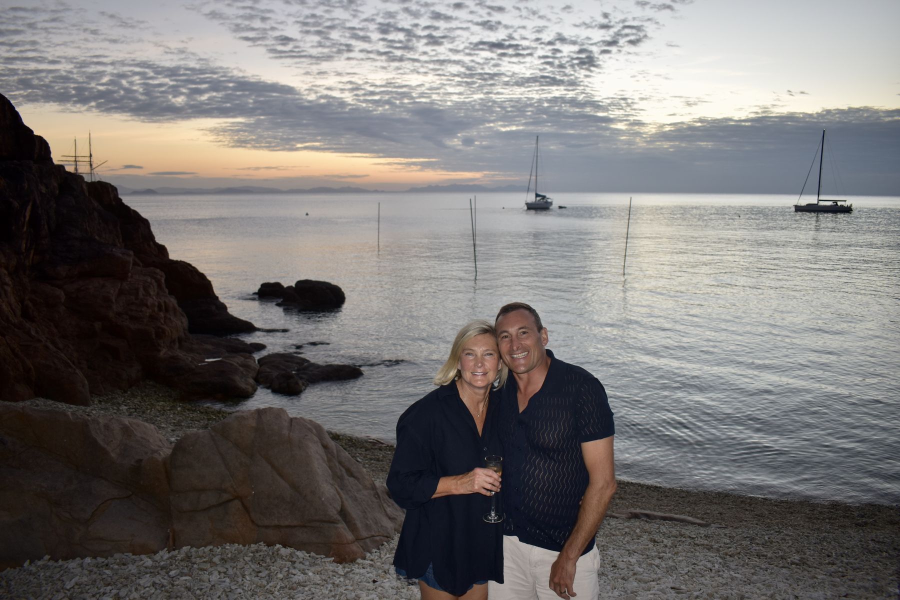 Couple portrait on the coral beach at golden hour
