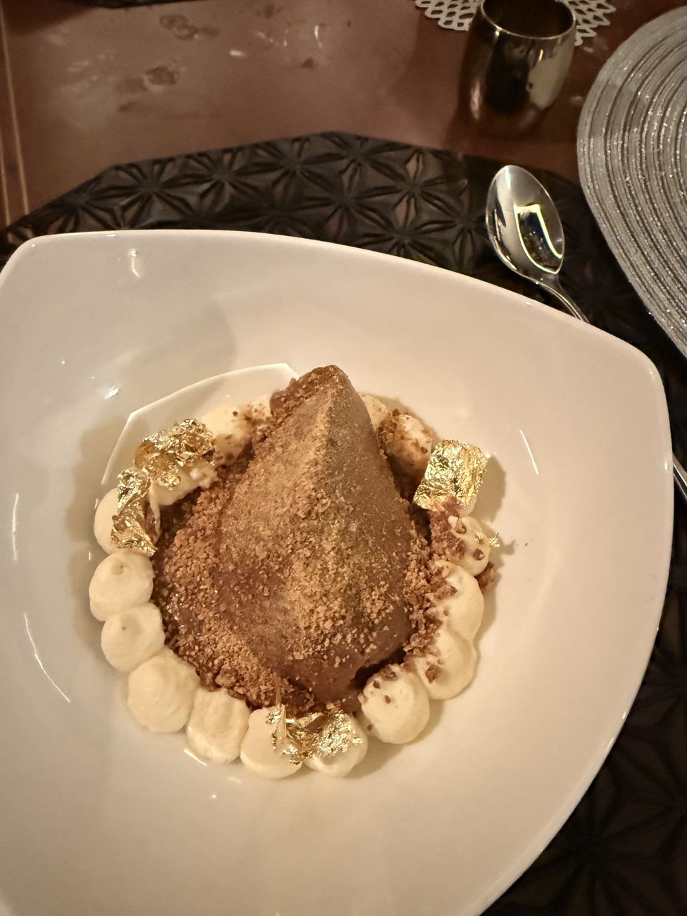 The 24-carat gold leaf dessert on a white plate