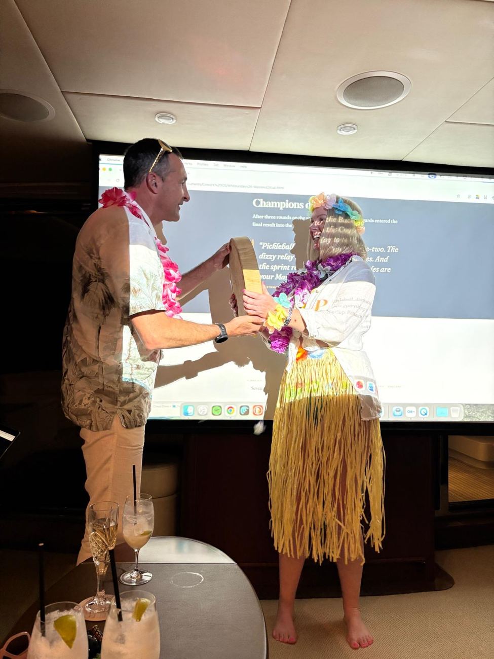 The grass-skirt trophy ceremony in front of the projected log