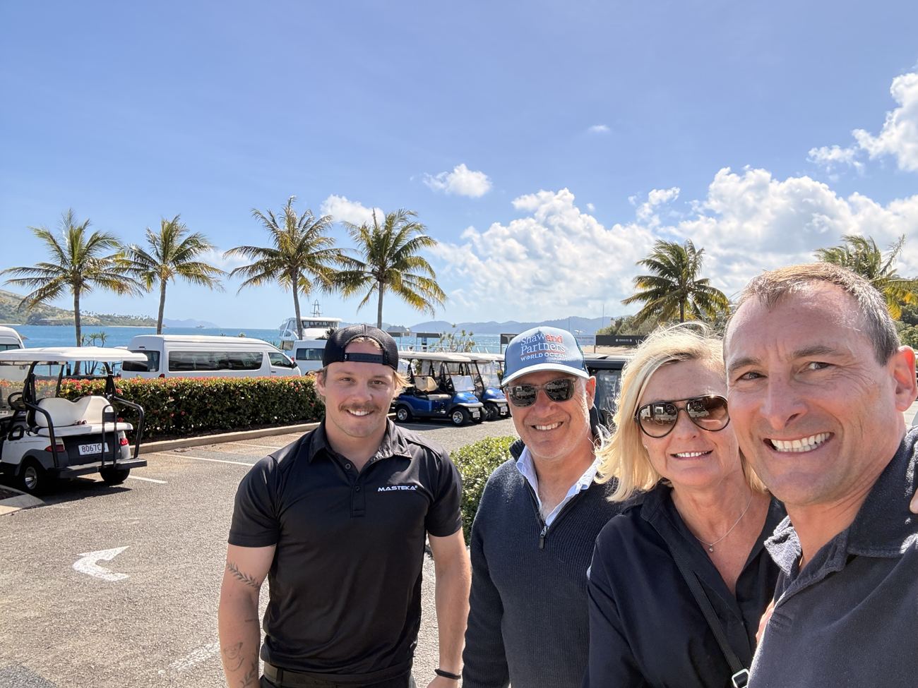Farewell group at Hamilton Island under the palms