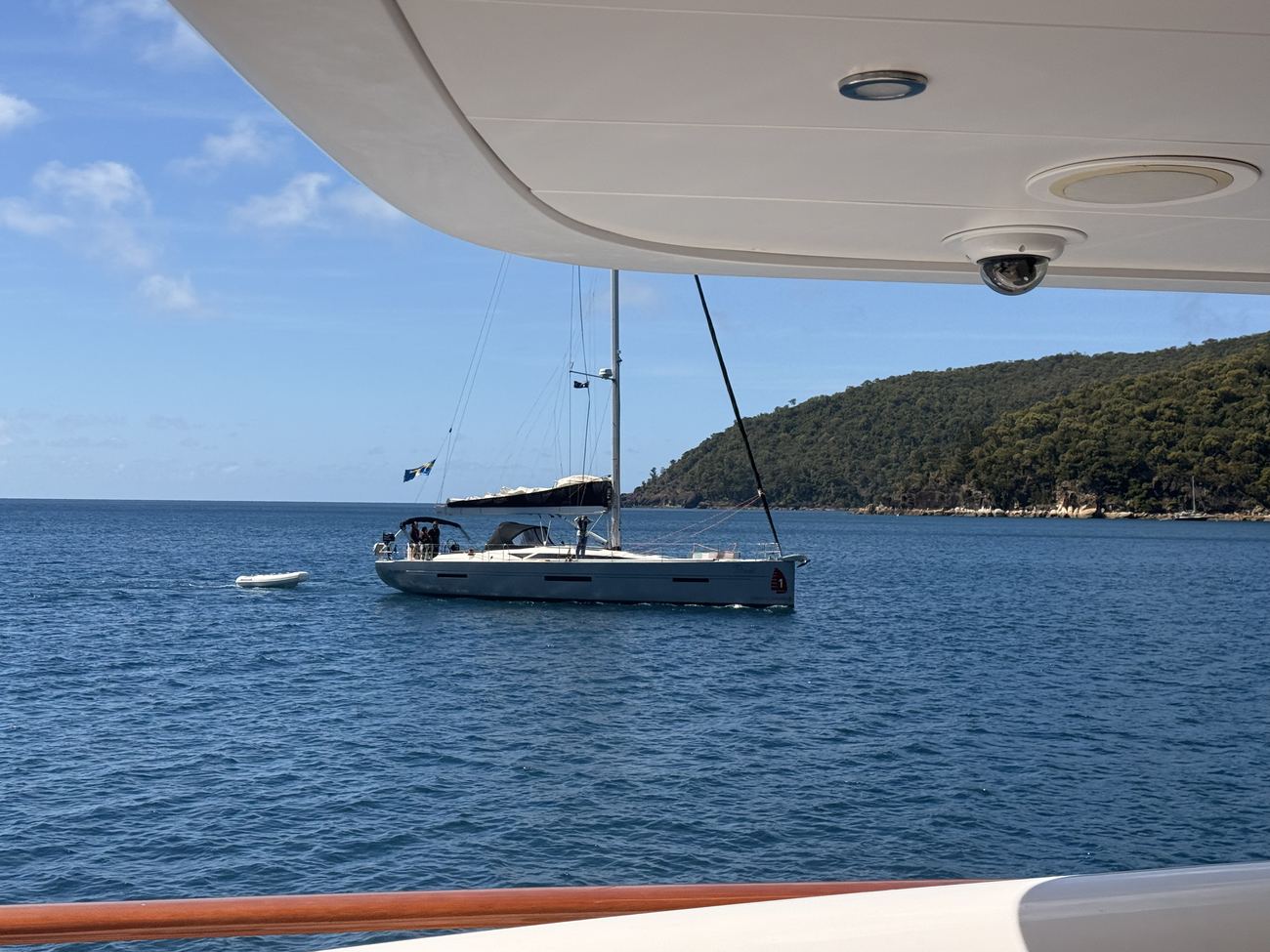 A sailboat at anchor nearby